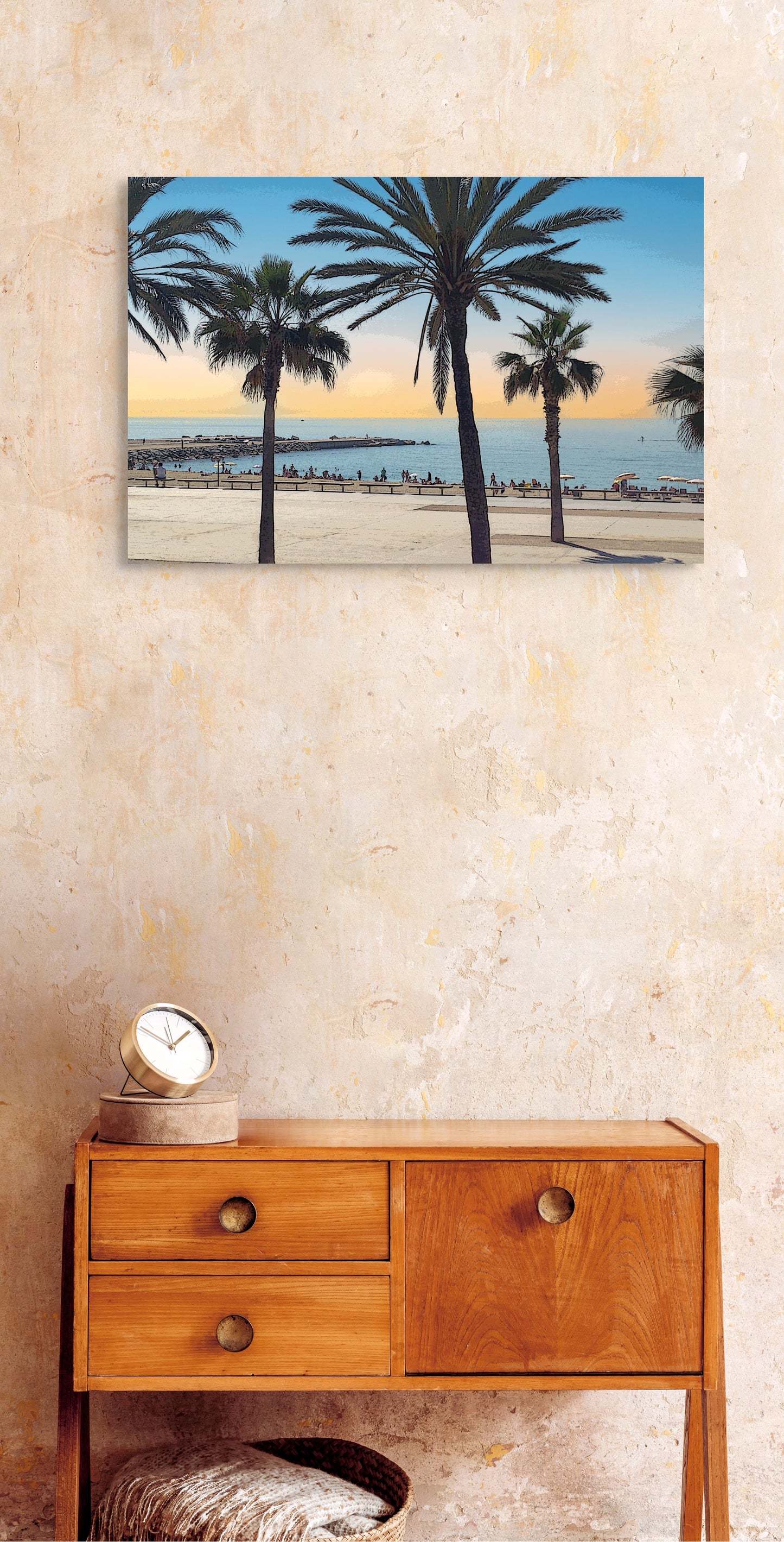 Spanish Beach Canvas Wall Art in bedroom with cream wall, wooden side table, gold clock, basket and blanket