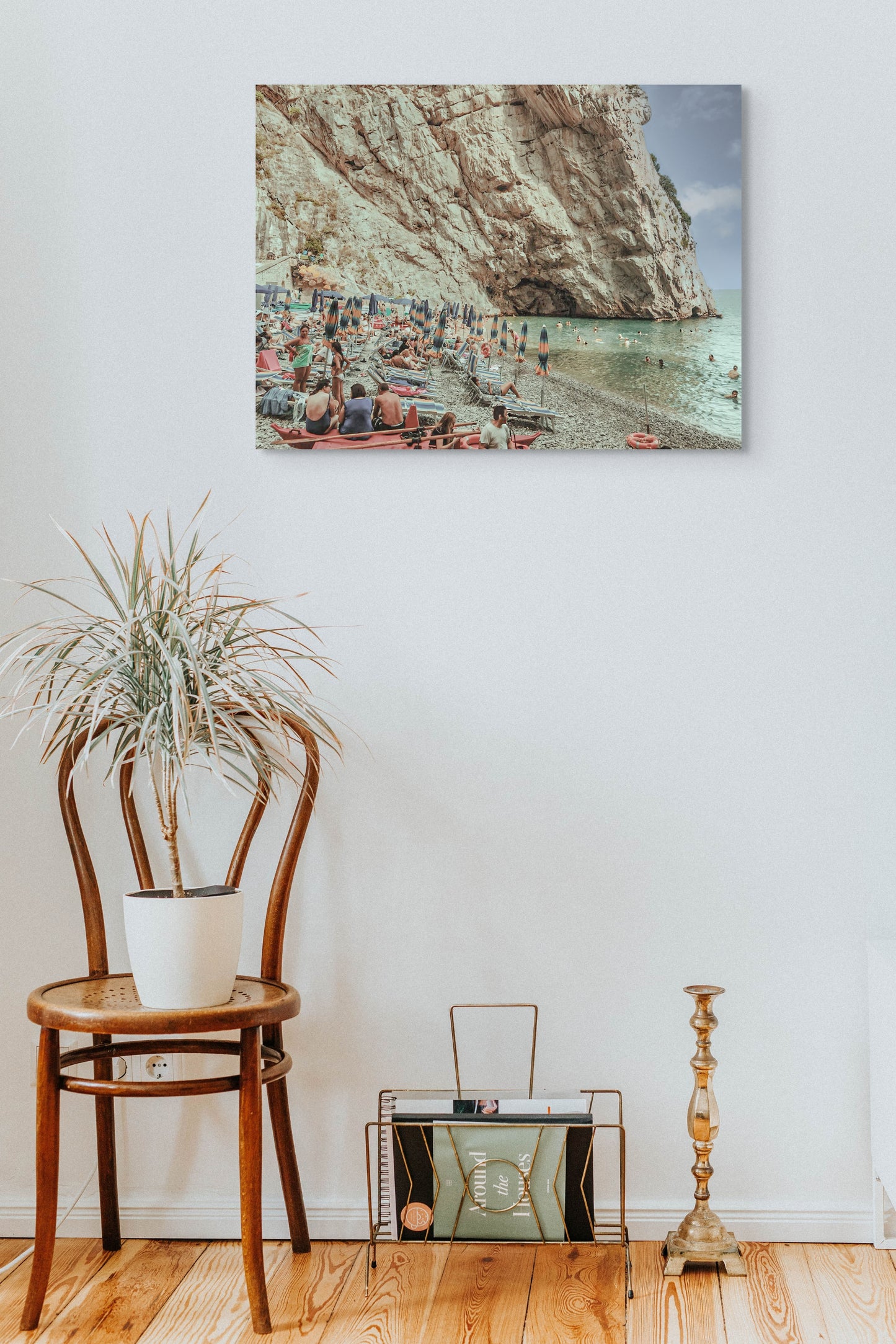 European Beach Canvas Wall Art in lounge room with white wall, brown chair, pot plant and gold candlestick