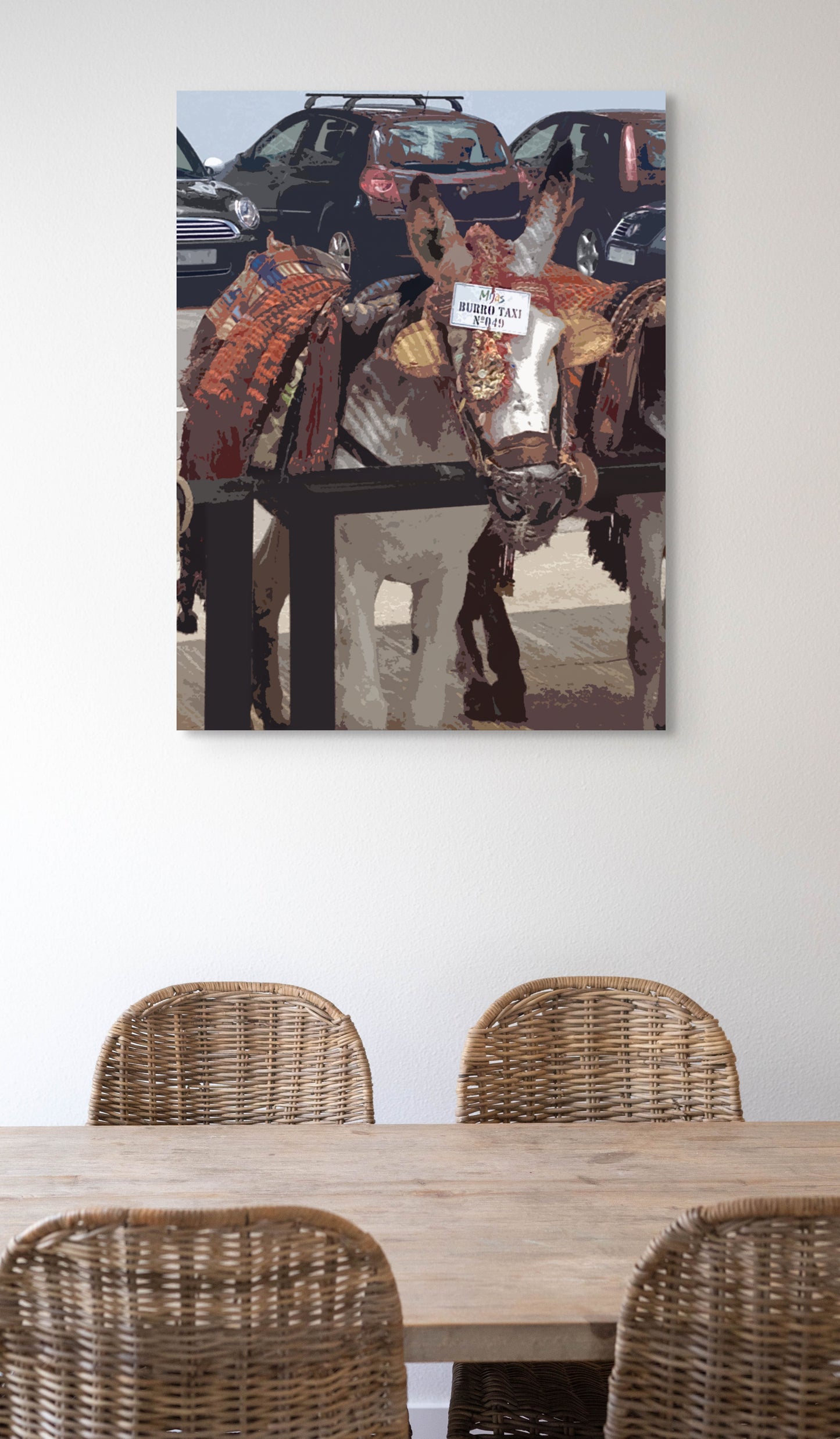 Burro Taxi Canvas Wall Art in kitchen with white wall, a wooden dining table and rattan chairs