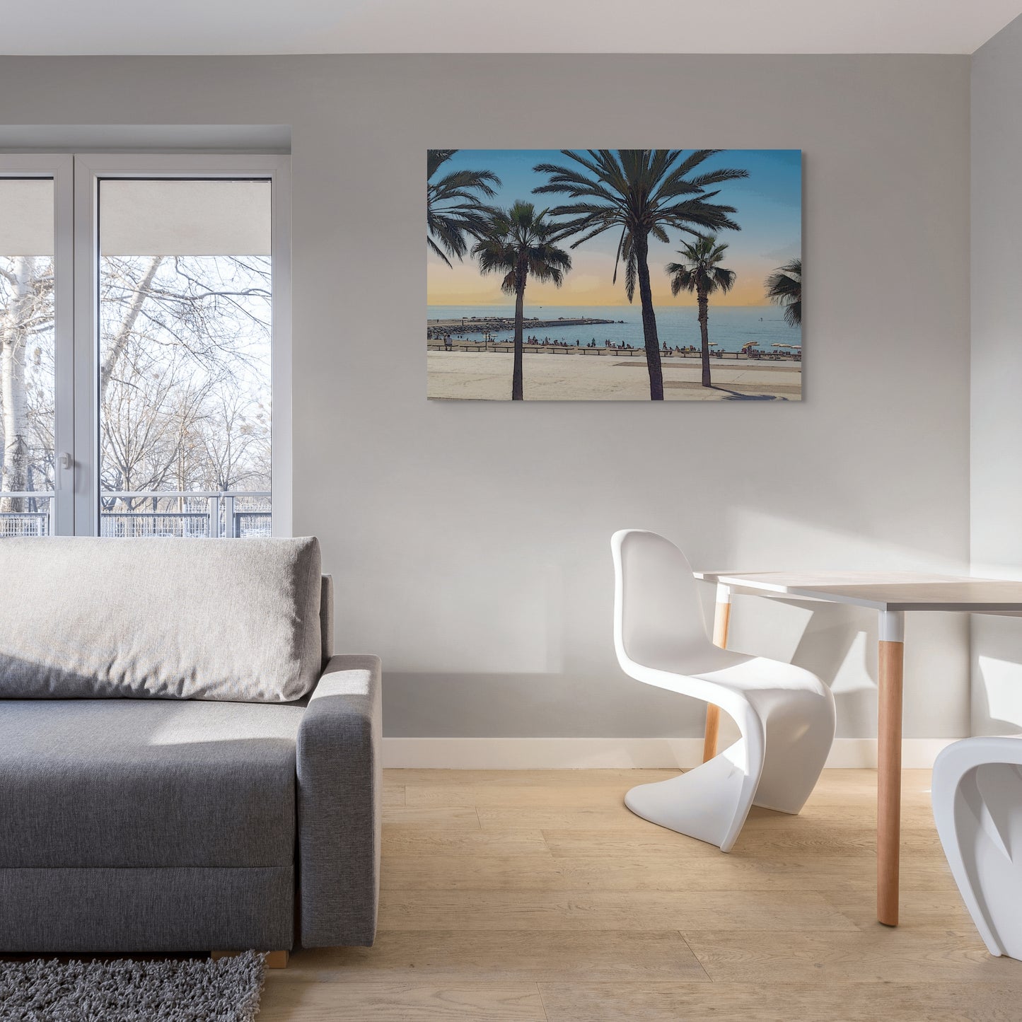 Spanish Beach Canvas Wall Art in lounge room with grey wall, grey lounge, wooden dining table, two white chairs and wooden floorboards