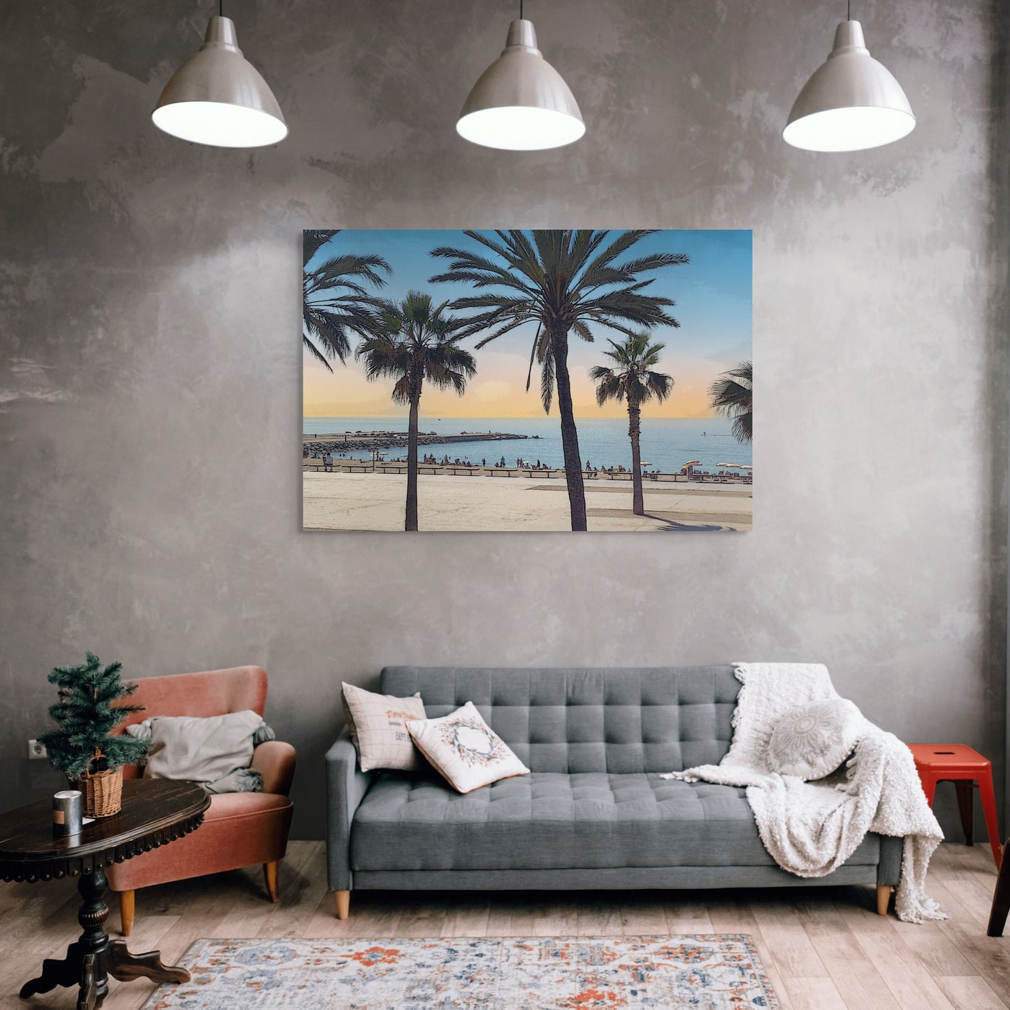 Spanish Beach Canvas Wall Art in lounge room with grey concrete wall with grey lounge, orange chair, white cushions, floor rug, wooden side table and three pendant lights