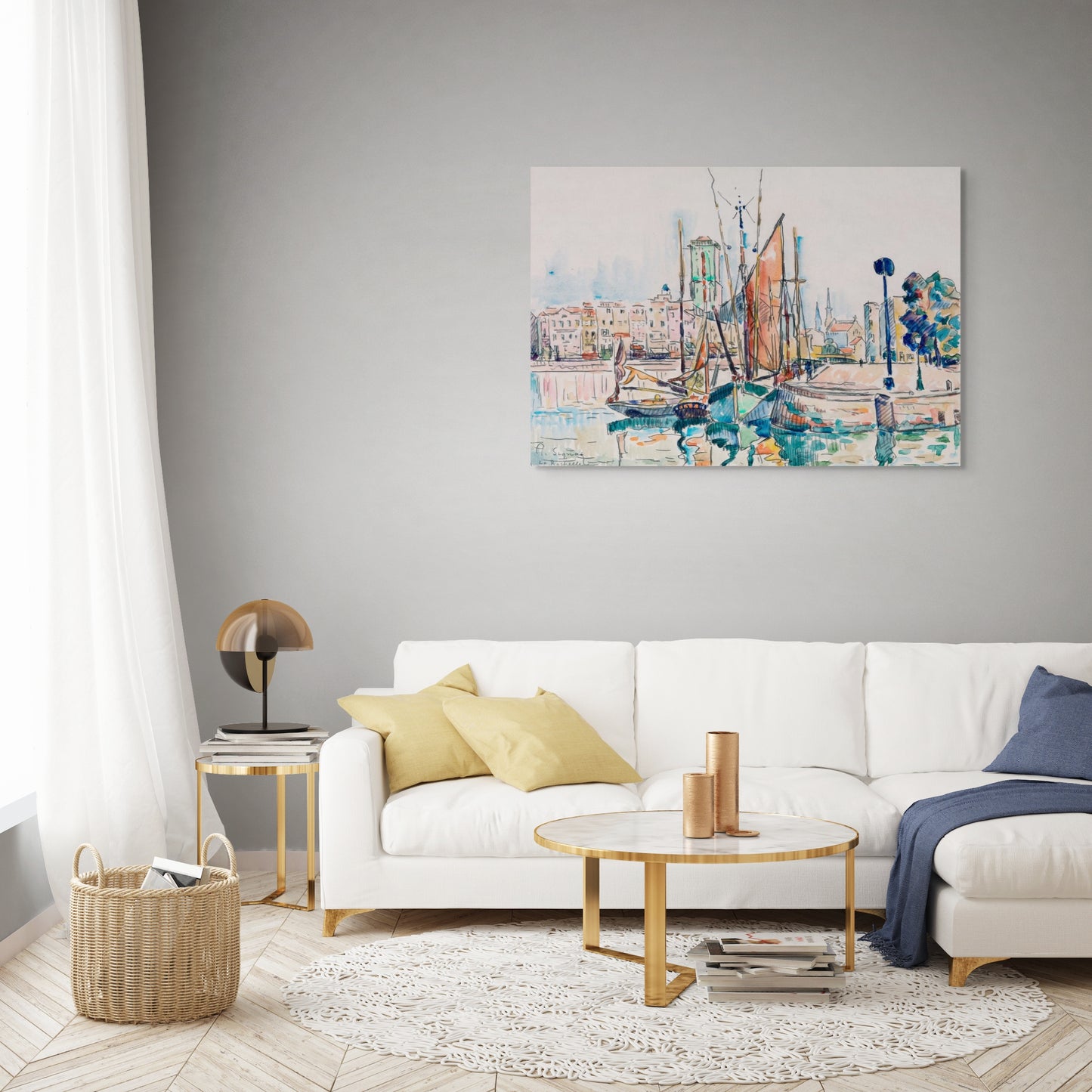 a living room with a white couch and a painting on the wall