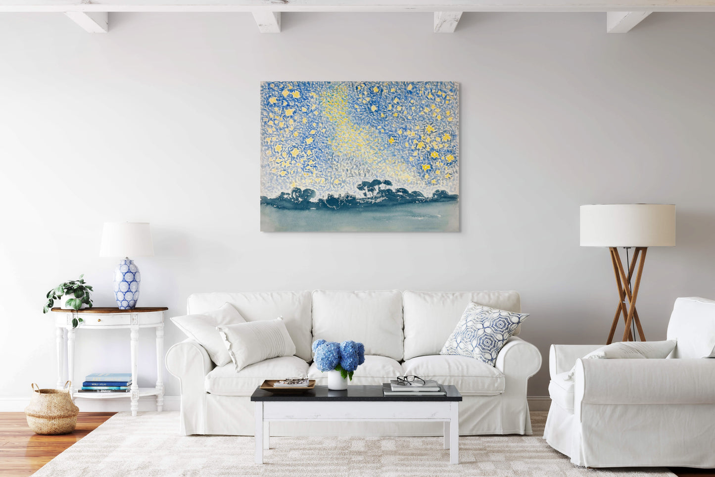 a living room with white furniture and a painting on the wall