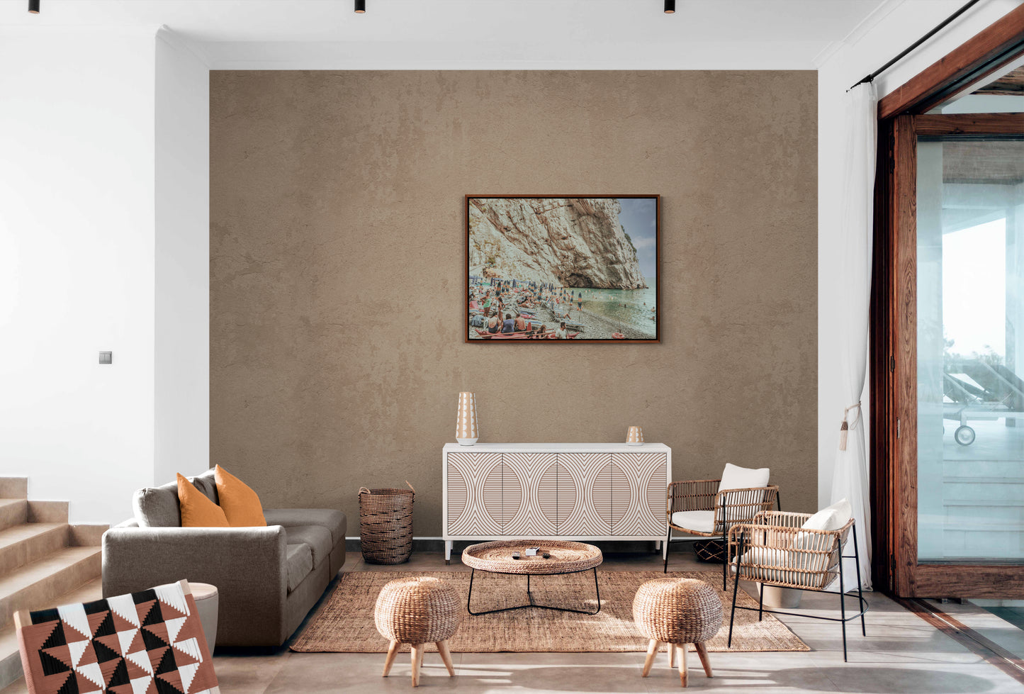 European Beach Canvas Wall Art in lounge room with brown wall, brown lounge and carpet and rattan chairs