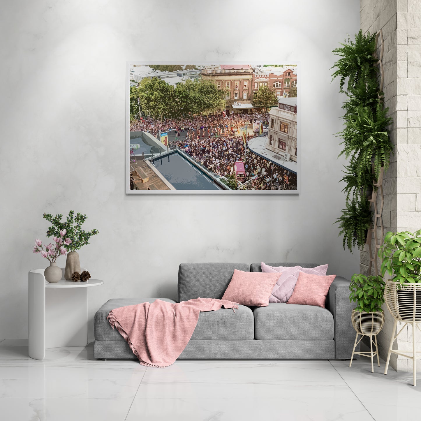 Mardi Gras Canvas Wall Art in lounge room with white wall, grey lounge, pink pillows and blanket, tiled floors and several pot plants