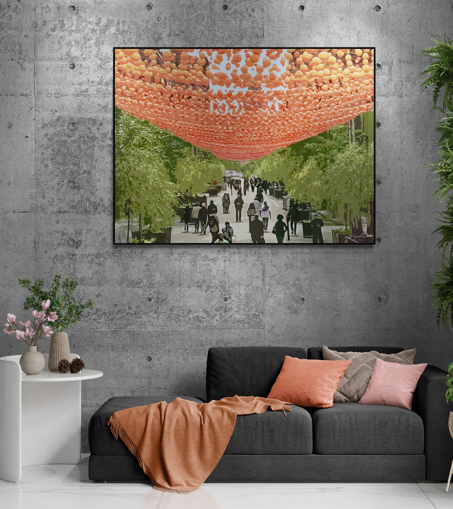 The Village Canvas Wall Art in lounge room with grey concrete wall, black lounge, orange blanket, several cushions, white side table, several pot plants and polished tile flooring