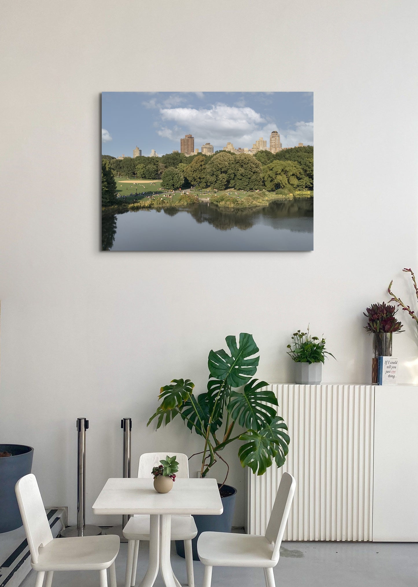 Central Park Canvas Wall Art in an office cafe with white table and wall and plant