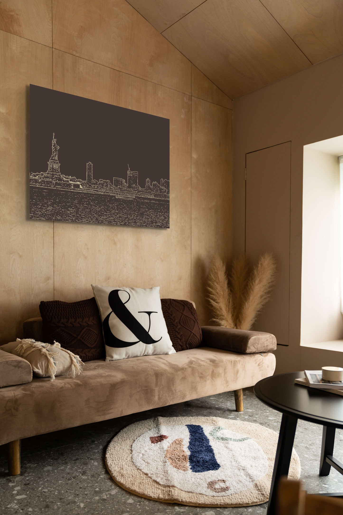 New York Skyline Canvas Wall Art in lounge room with brown panel walls, brown lounge, round rug and black coffee table