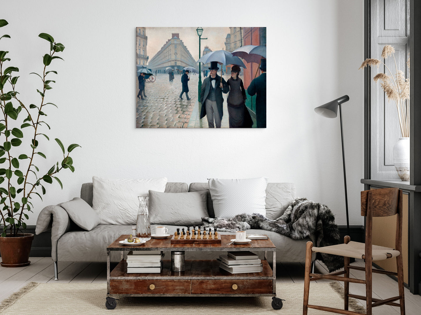 a living room filled with furniture and a painting on the wall