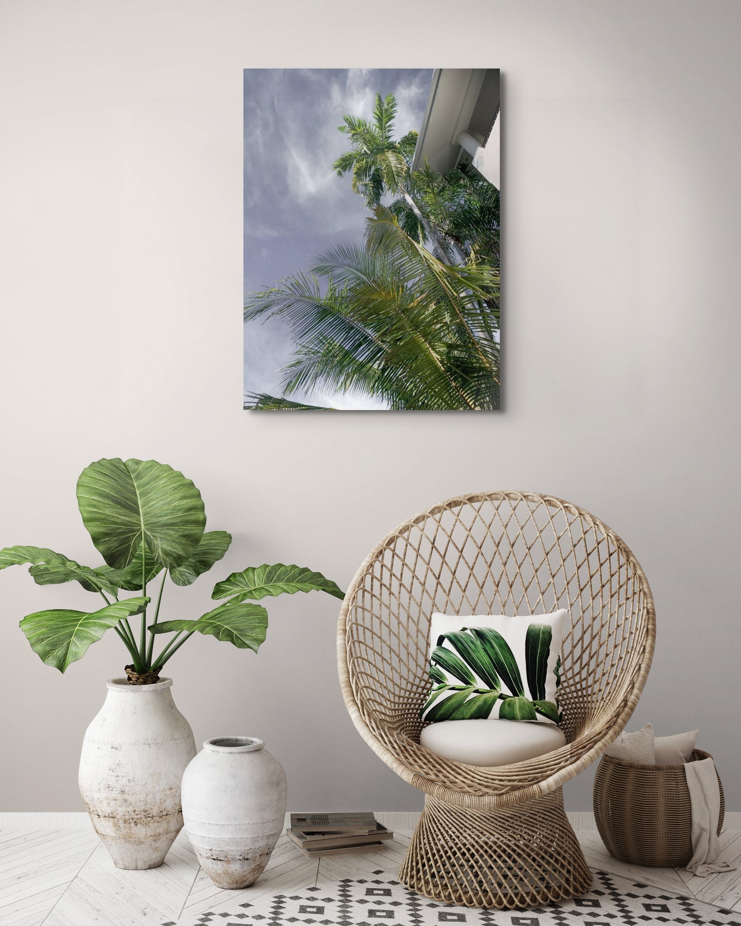 Palm Tree Dreaming Canvas Wall Art in lounge room with light brown wall, two pot plants, small peacock chair and rattan basket