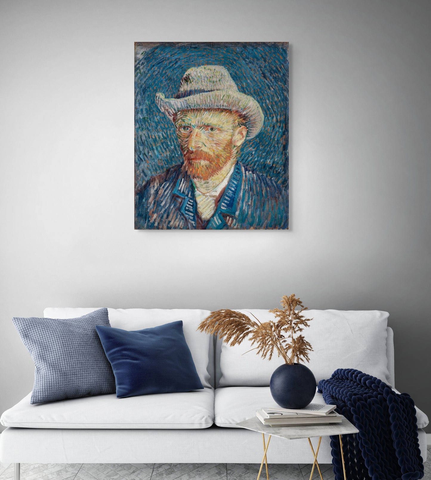 a living room with a white couch and a painting on the wall