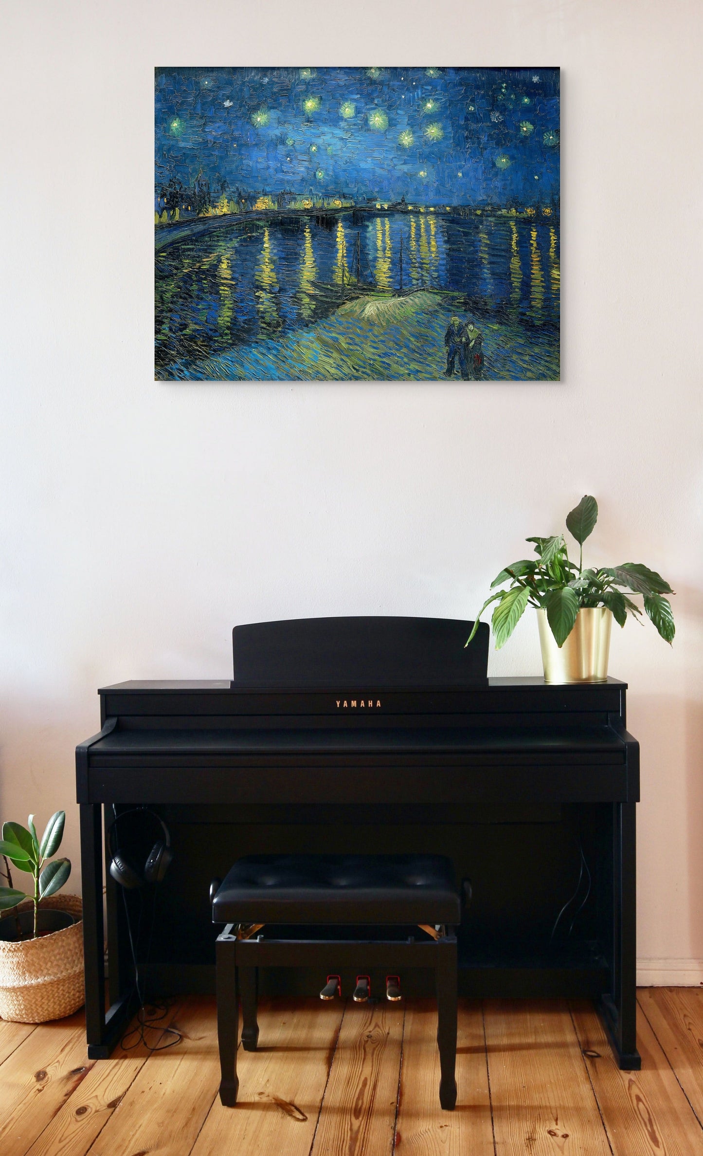 a piano in a room with a painting on the wall