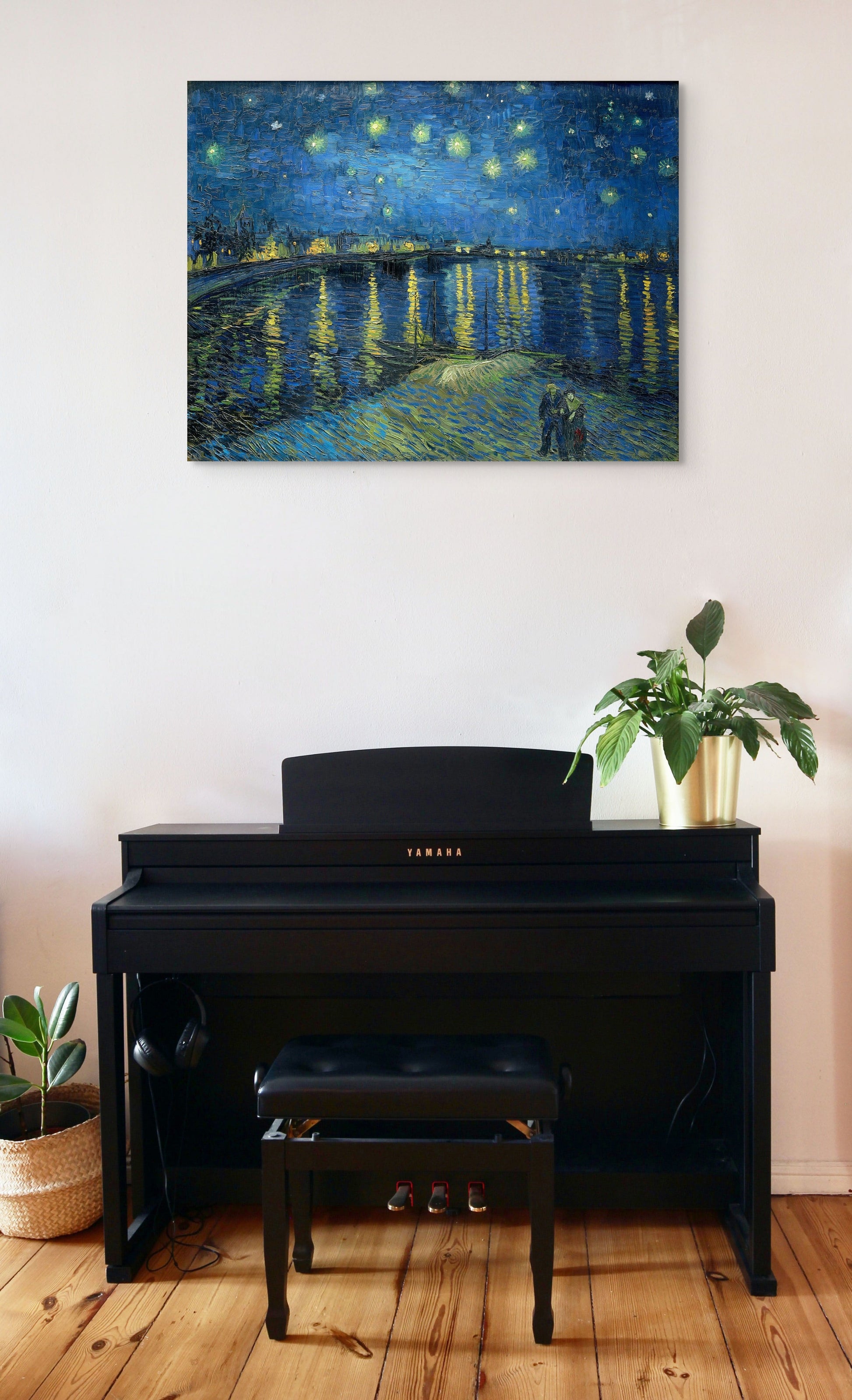 a piano in a room with a painting on the wall