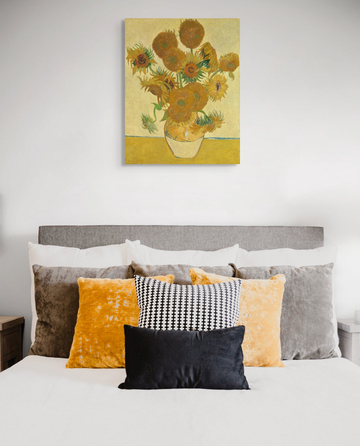 a bedroom with a bed and a painting on the wall
