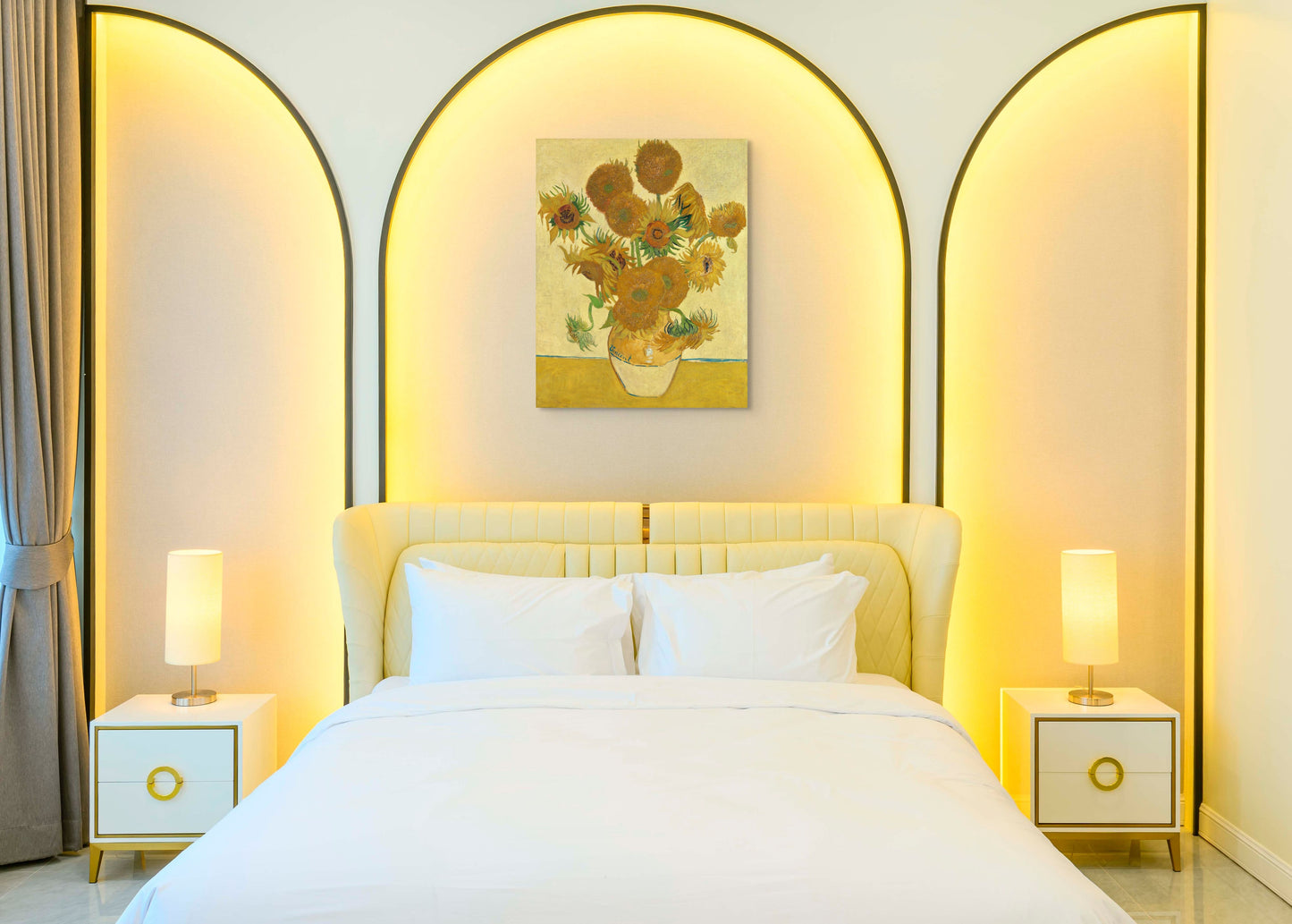 a bedroom with a white bed and a painting on the wall