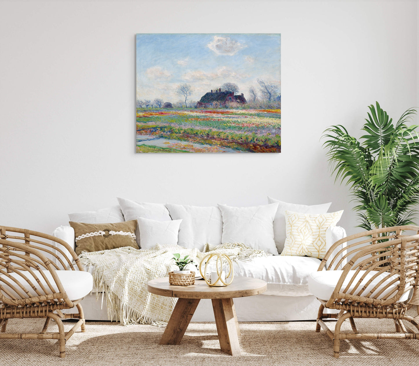 a living room with wicker furniture and a painting on the wall