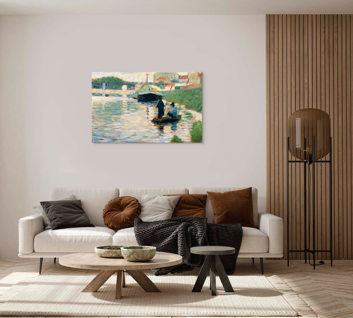 a living room with a white couch and a painting on the wall