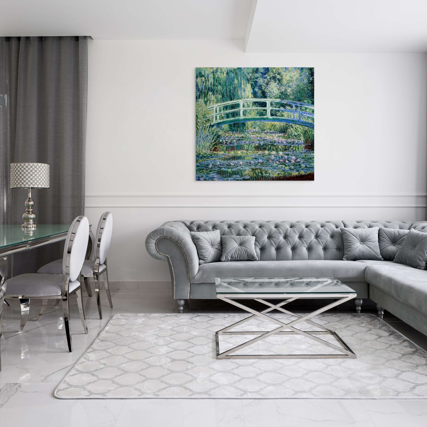 a living room with a gray couch and a glass table