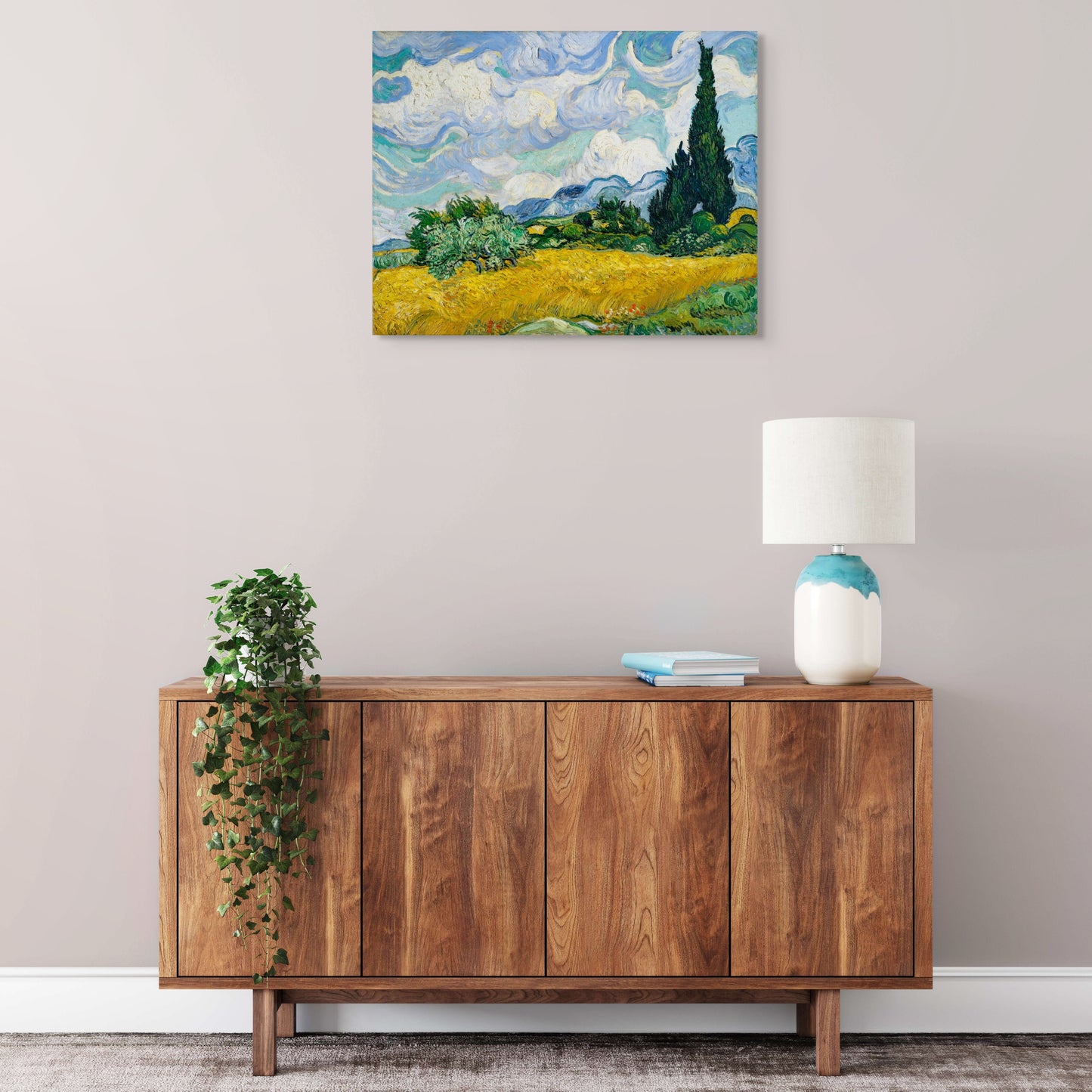 a painting on a wall above a wooden cabinet