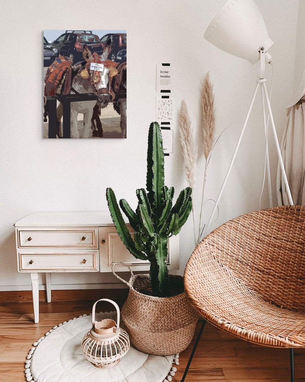 Burro Taxi Canvas Wall Art in bedroom with cactus and rattan chair