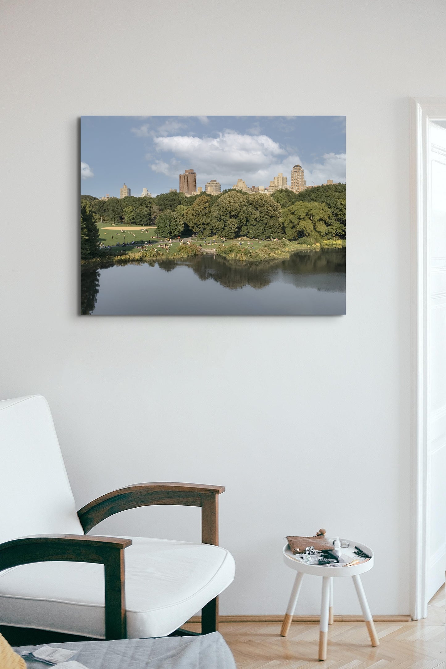 Central Park Canvas Wall Art in lounge room with white wall and white sofa chair and side table