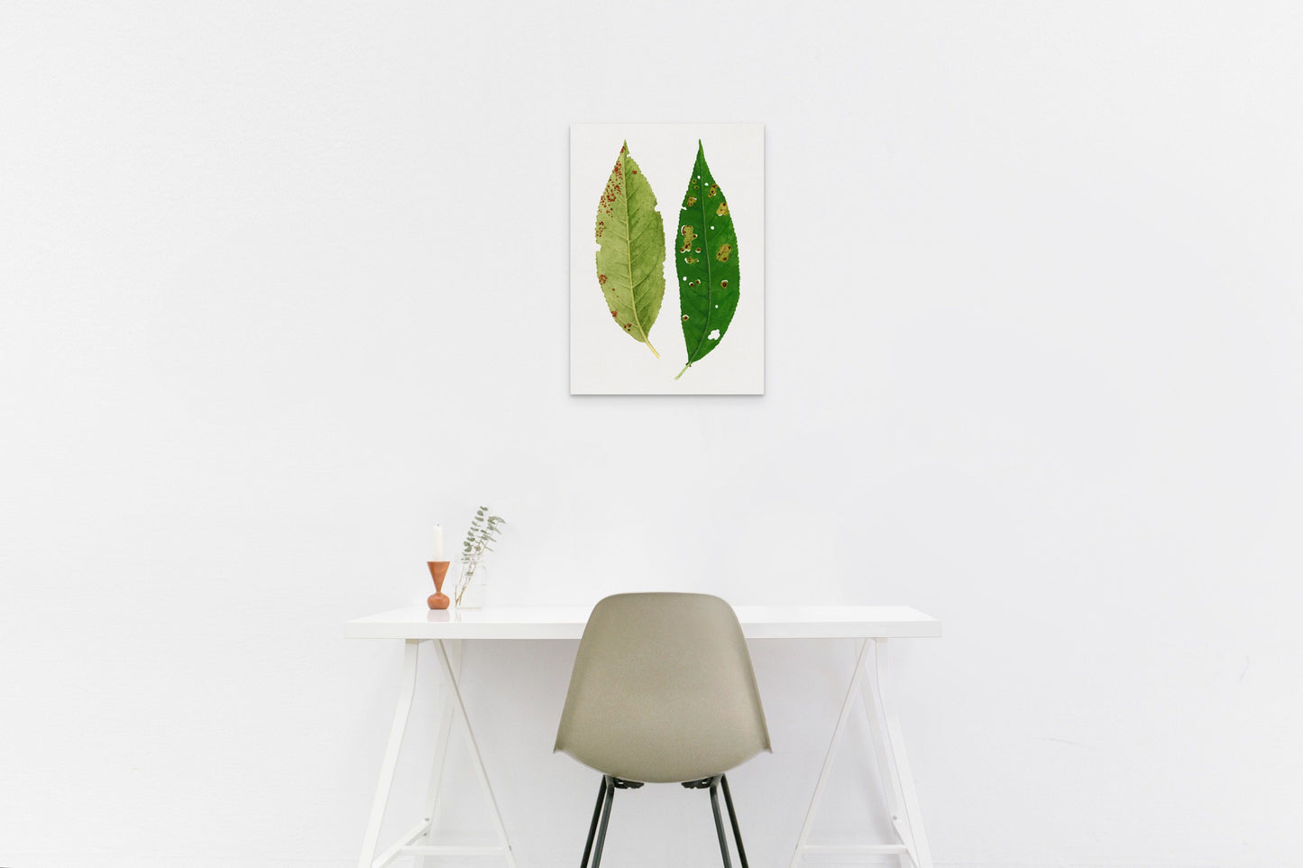 a white table with a chair and a painting on the wall