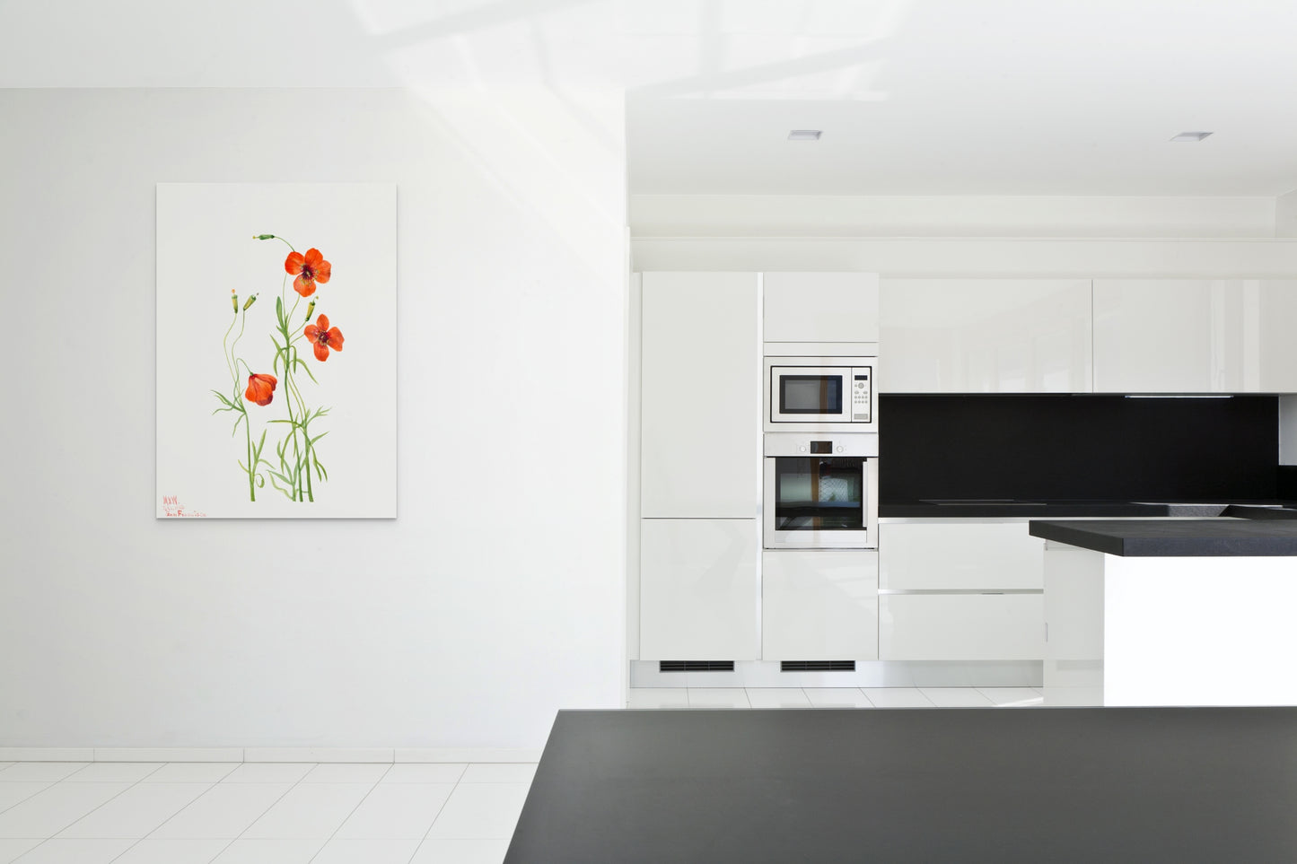 a kitchen with white cabinets and black counter tops