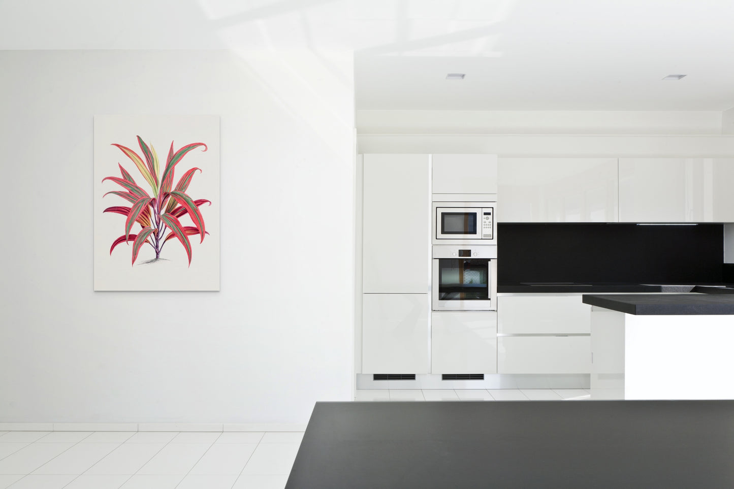 a kitchen with a black counter top and white cabinets