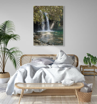 Rainforest Canvas Wall Art in bedroom with white wall, wooden rattan bedframe, white quilt, several pillows, wooden side table, two pot plants, basket and light wooden floorboards