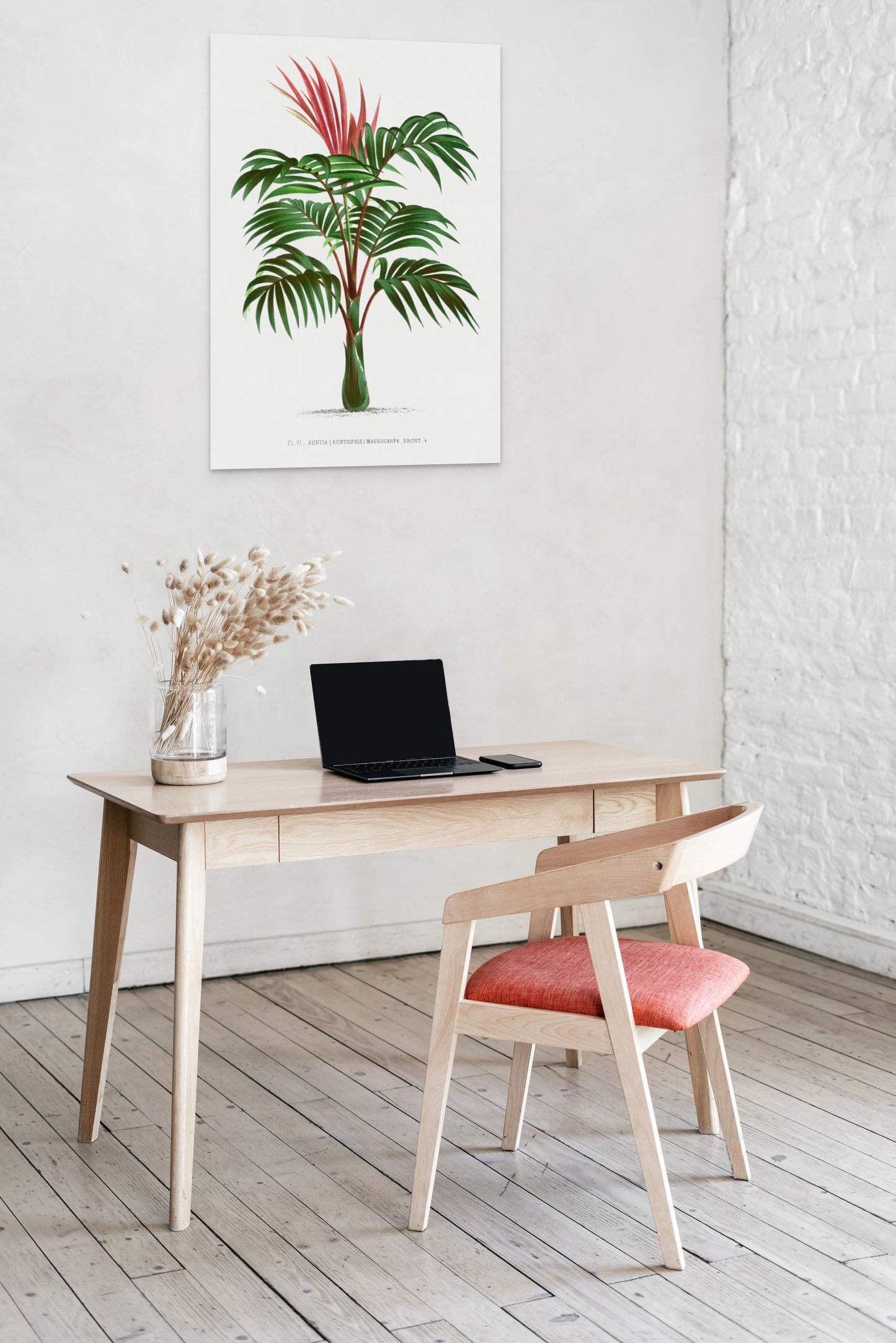 a desk with a laptop and a plant on it
