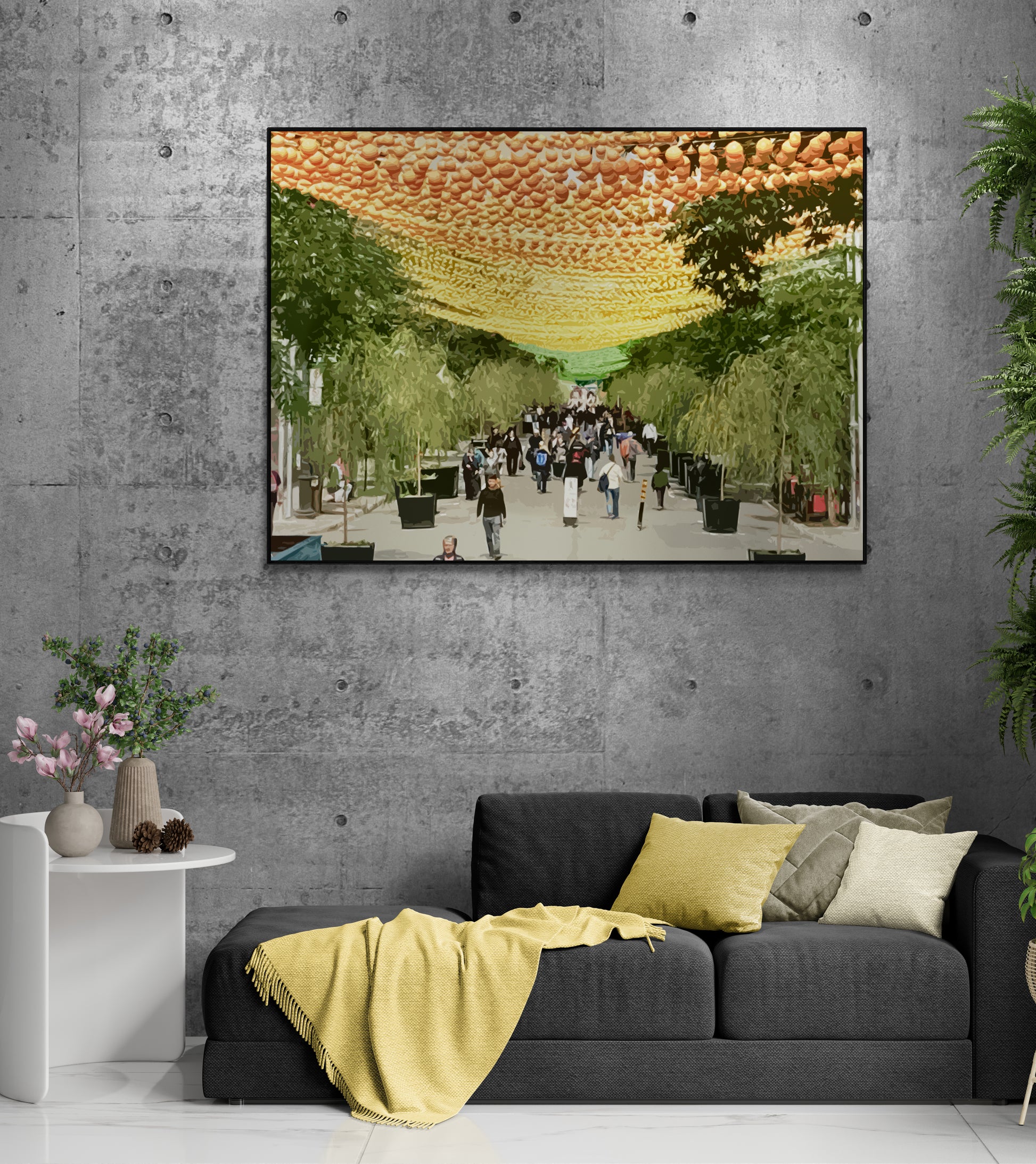 The Village Canvas Wall Art in lounge room with grey concrete wall, black lounge, yellow blanket, several cushions, white side table, several pot plants and polished tile flooring