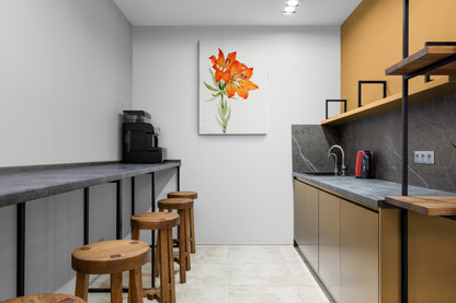 a kitchen with a counter, stools and a painting on the wall